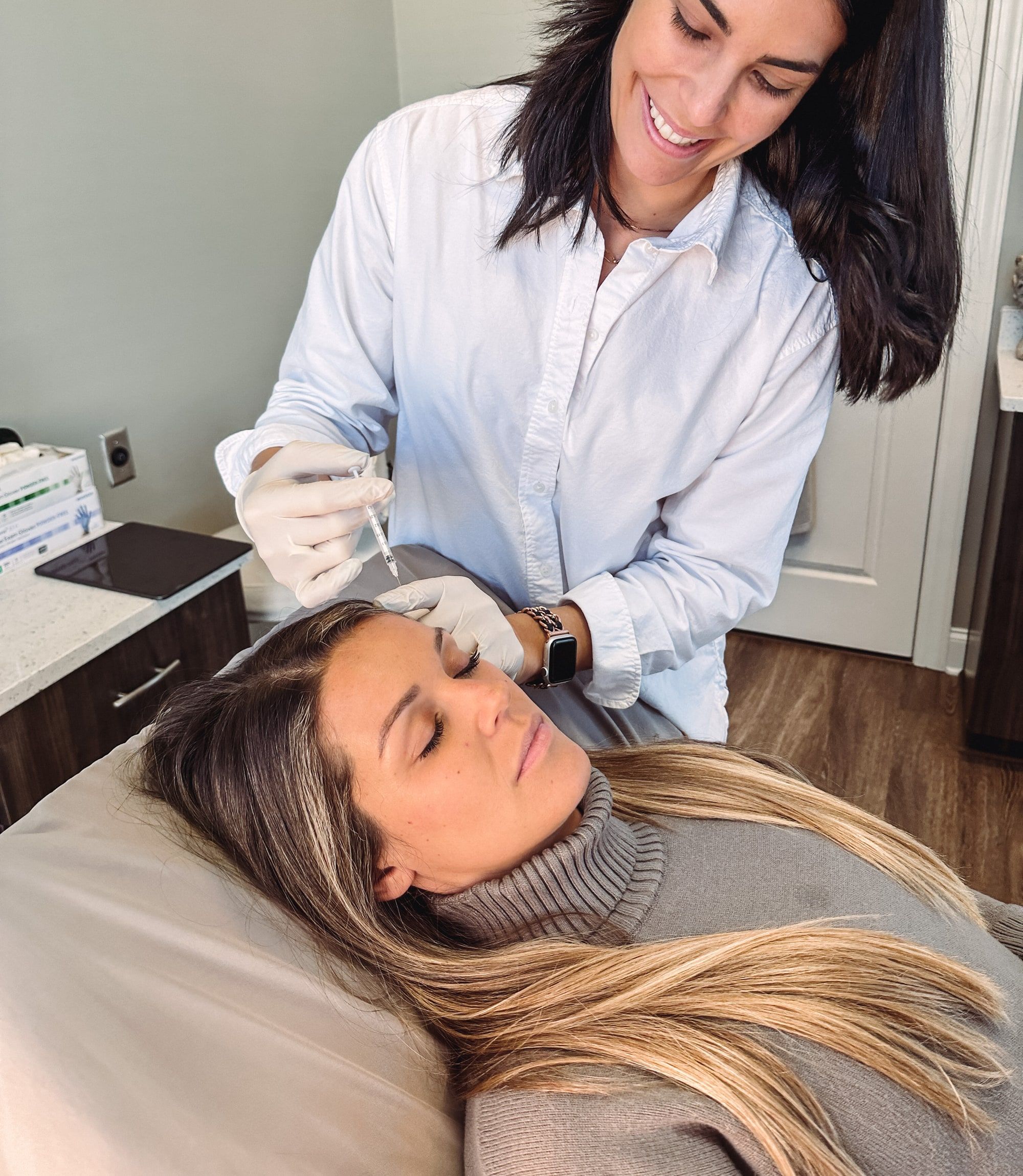 Ashley Corey, DO treating a patient at Wellspring Skincare in Roswell